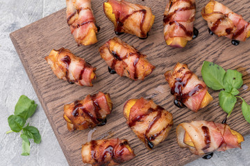 Grilled bacon wrapped peach with balsamic vinegar