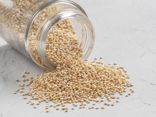 Grain of quinoa in bank on gray background