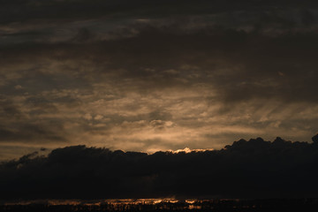  Sunset against the background of the evening sky with colorful shades of flowers on the clouds