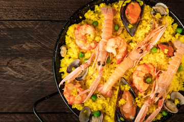 Closeup of Spanish seafood paella in paellera with copyspace
