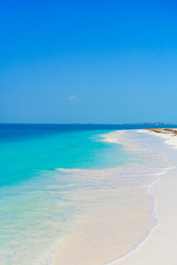 Perfect white sandy beach with turquoise water and blue sky. Amazing picture