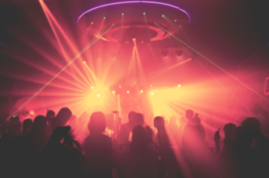 blur Light in club party Show And Silhouette of audience crowd people  enjoying the club party with concert. Blurry night club DJ party people enjoy of music dancing sound