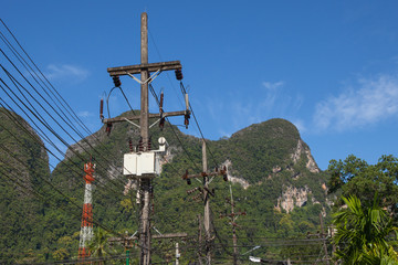 Fototapeta premium electricity pole in blue sky at thailand