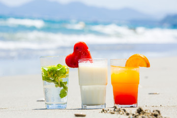 summer cocktails with a blur beach in the background