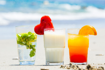 summer cocktails with a blur beach in the background