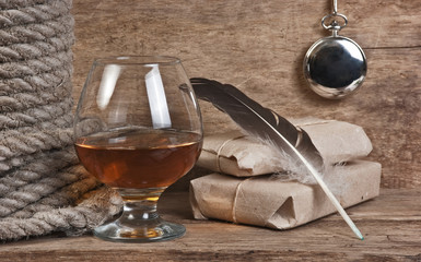 quill in the inkwell and glass of wine
