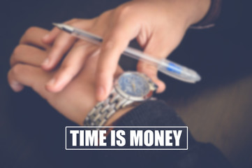 time is money with businessman looking at his watch blurring background, financial concept