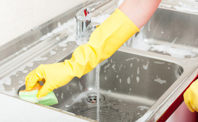 Housewife is cleaning kitchen sink in close-up