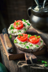 Closeup of sandwich with fromage cheese, chive and cherry tomatoes