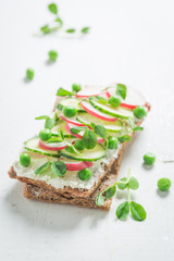 Sandwich with avocado, creamy cheese and peas