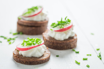 Closeup of sandwich with pumpernickel, cottage cheese and chive