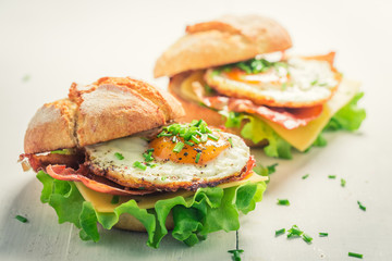 Closeup of delicious burger with eggs, cheese and bacon