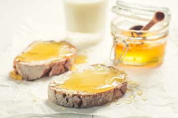 Closeup of sandwich with honey with milk for breakfast