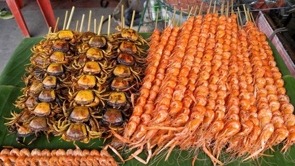 Crab and shrimp in stick grill.