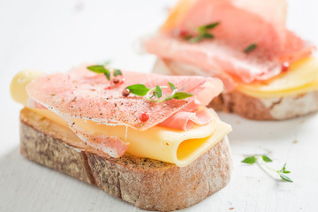 Sandwich with ham and cheese for breakfast on white table