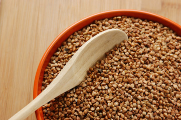 buckwheat groats in a bowl on a wooden table