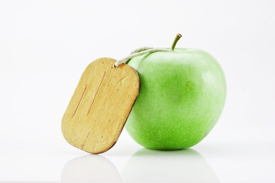 green apple with tag on white background