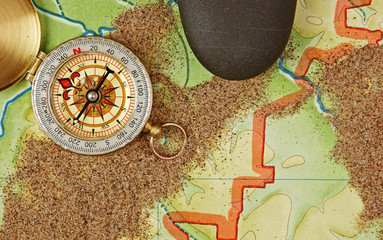 compass on the map with sand