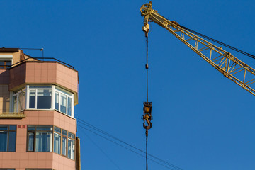 Hook of the tower crane. The end of the construction of an apartment building