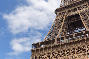 close up o Eiffel tower against blue sky with clouds