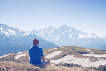 Fototapeta premium Man traveler admiring a epic view of peaks