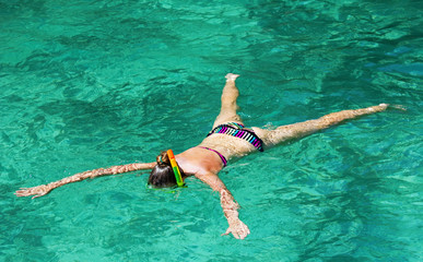 young girl on the beach snorkel Maya Bay on Phi Phi Ley, Thailand