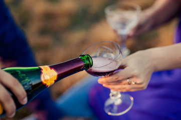 The waiter pours champagne in crystal glasses