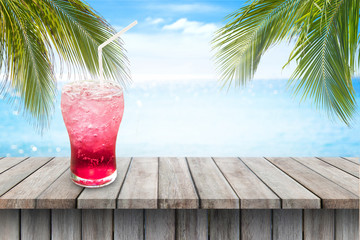 iced red italian soda fresh juice on Empty wood table and sea view background.summer fresh concept.drink of summer