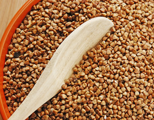 buckwheat groats in a bowl on a wooden table