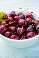 cherries on a turquoise wooden surface