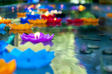 Purple lotus shape candle lit and float on water