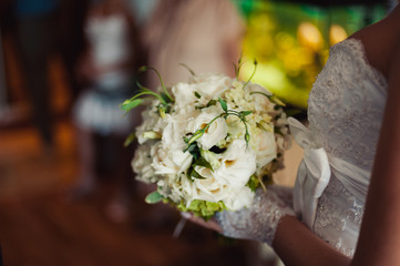 Bride holding big wedding bouquet on wedding ceremony