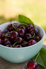cherries on a turquoise wooden surface