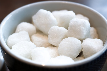 Fototapeta na wymiar White sugar cubes in a bowl with nature light.