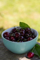 cherries on a turquoise wooden surface