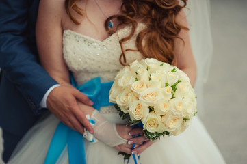 Bride holding big wedding bouquet on wedding ceremony