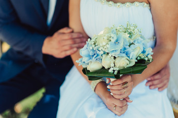 Bride holding big wedding bouquet on wedding ceremony