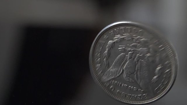 Metal Coin Spinning in Slow Motion. United States of America Quarter Dollar Coin. Economy Concept