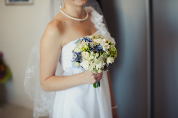 Bride holding big wedding bouquet on wedding ceremony