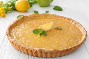 Lemon pie on white wooden table