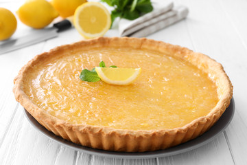 Lemon pie on white wooden table