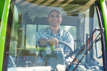 Farmer driving a tractor in his field © Minerva Studio