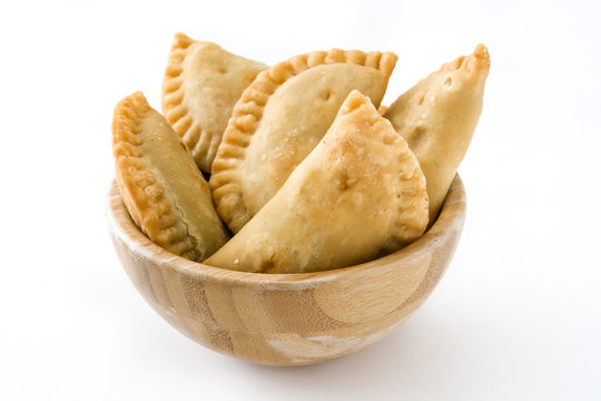 Typical Spanish empanadas in bowl isolated on white background
