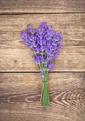 Bouquet of lavender on rustic brown wooden background 