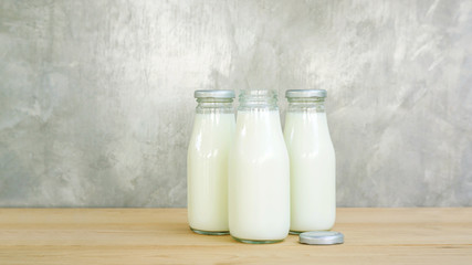 a bottle of milk on a wooden table.