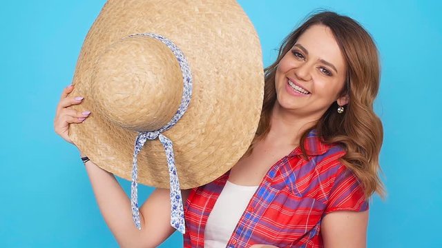 Young woman with hat over blue background
