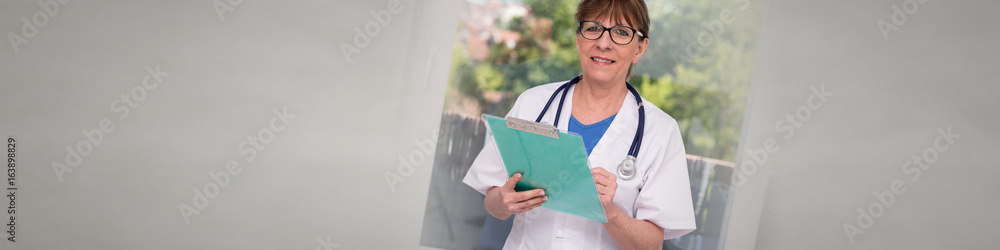 Wall mural Portrait of female doctor holding a clipboard