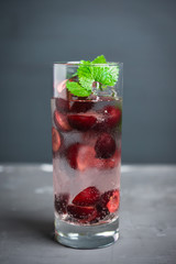 Cherries mojito on the wooden background. Selective focus.