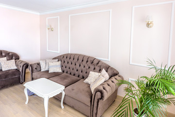 White apartment interior design living room with classic furniture, sofa and white table, flower and tv audio set, modern style in chisinau, cenral district, moldova