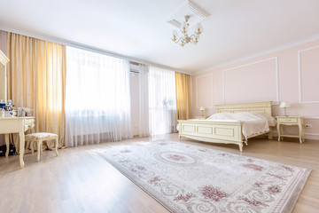 White apartment interior design bedroom with classic furniture, curtains, modern style in chisinau,...